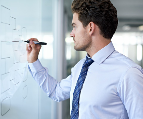 man writing on whiteboard